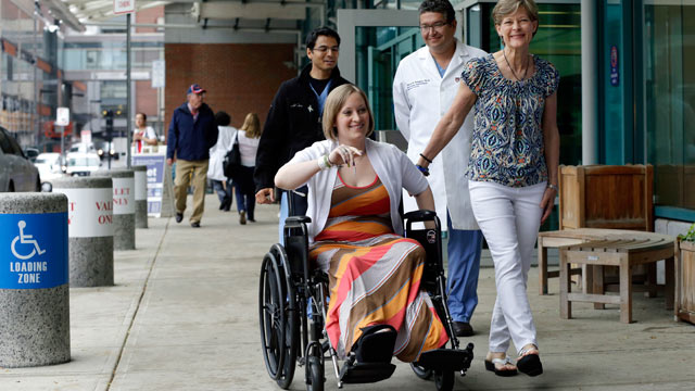 PHOTO: Boston Marathon bombing survivor Erika Brannock, 29, a Baltimore area pre-school teacher who lost a leg, is accompanied by her mother, Carol Downing, right, as she is released from Beth Israel Deaconess Medical Center in Boston, June 3, 2013.