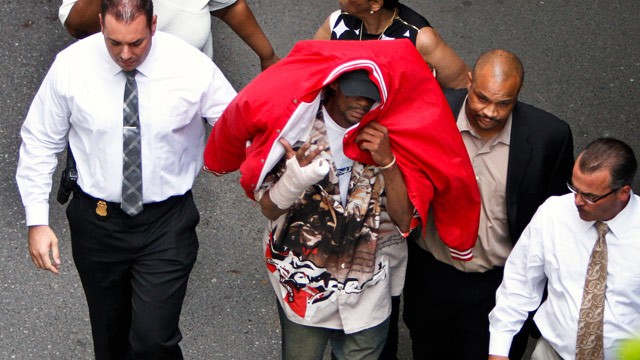 PHOTO: Sean Benschop, center, with red jacket over his head, walks with investigators as he arrives at the Philadelphia Police Departments Central Detectives Division, Saturday June 8, 2013, in Center City Philadelphia.