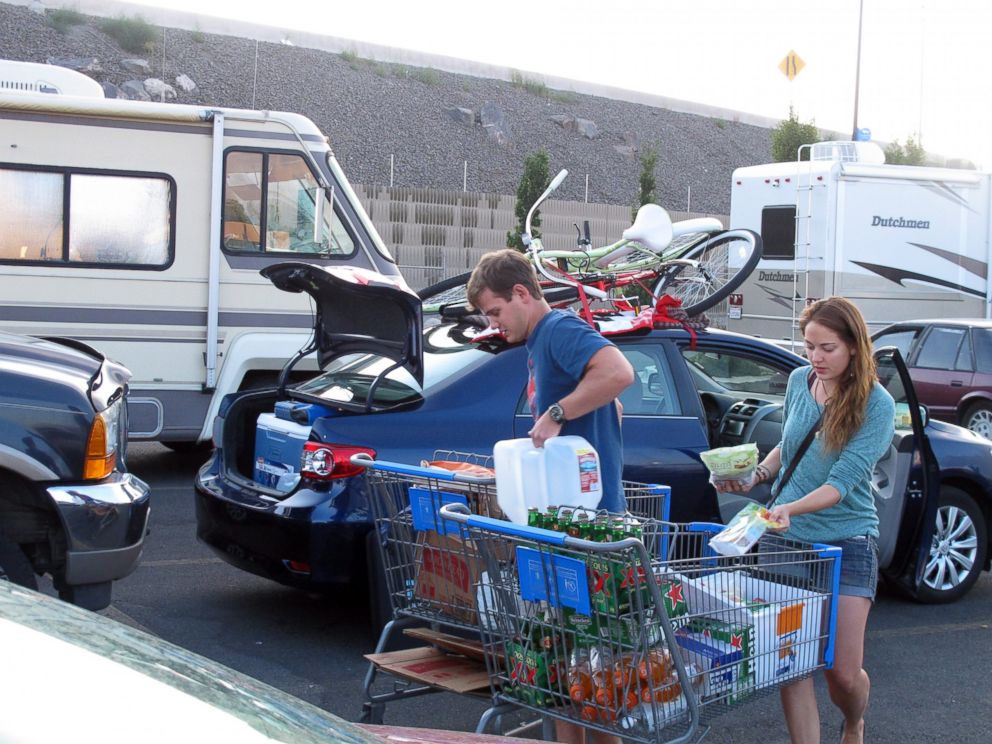 PHOTO: Jeff Difabrizio, left, and Jahliele Paquin of Yellowknife, Canada, load up provisions in the parking lot of a Wal-Mart, Aug. 25, 2014, in Reno, Nev., on their first trek to Burning Man.