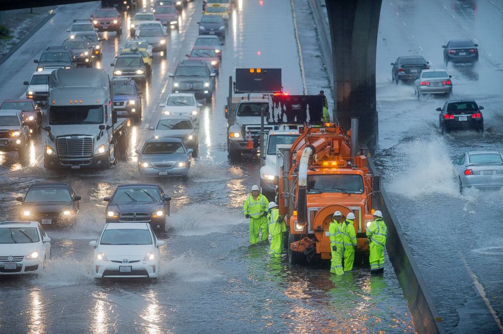 PHOTO: A Caltrans crew tries to clear a flooded stretch of Highway 101 in South San Francisco, Calif., Dec. 11, 2014.