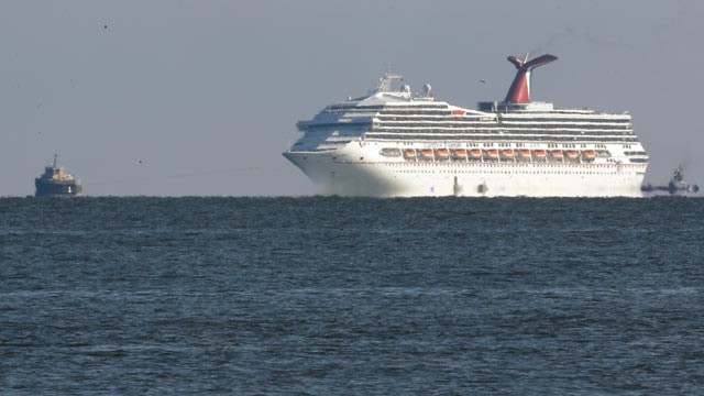 PHOTO: The cruise ship Carnival Triumph is towed towards Mobile Bay near Dauphin Island, Ala., Feb. 14, 2013.