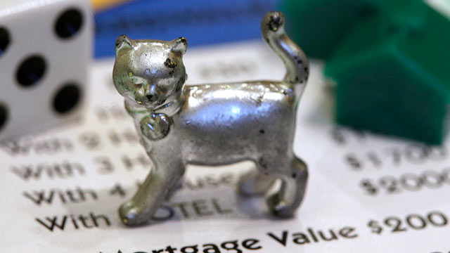 PHOTO: The newest Monopoly token, a cat, rests on a Boardwalk deed next to a die and houses at Hasbro Inc. headquarters, in Pawtucket, R.I., Feb. 5, 2013.