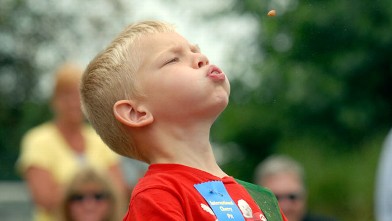 PHOTO: Morgan Krause, 5, from Diamond Dale, Mich., launches a cherry pit 15 feet, 11 inches, to win the youth five and under division, July 4, 2009, during the International Cherry Pit Spitting Championship held at Tree-Mendus Fruit Farm in Eau Claire, Mi