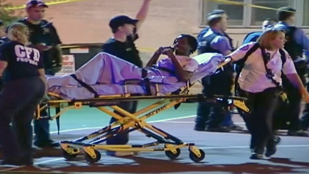 PHOTO: In this still frame made from Sept. 19, 2013, video provided by Ken Herzlich, officials and emergency responders tend to a victim at the scene where a number of people, including a 3-year-old child, were shot in a city park in Chicago.