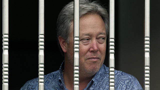 PHOTO: American Chip Starnes, co-owner of Specialty Medical Supplies looks out from a window as he is held hostage by angry workers inside his plant at the Jinyurui Science and Technology Park in Qiao Zi township of Huairou District, on the outskirts of B