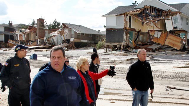 PHOTO: New Jersey Gov. Chris Christie, center left, passes damaged homes along the Atlantic Ocean, Nov. 2, 2012, in Mantoloking, N.J., as they tour some of the region devastated by superstorm Sandy.