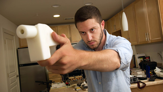 PHOTO: Cody Wilson poses with the plastic pistol that he created with a 3-D printer, at his home in Austin, Texas, May 10, 2013.