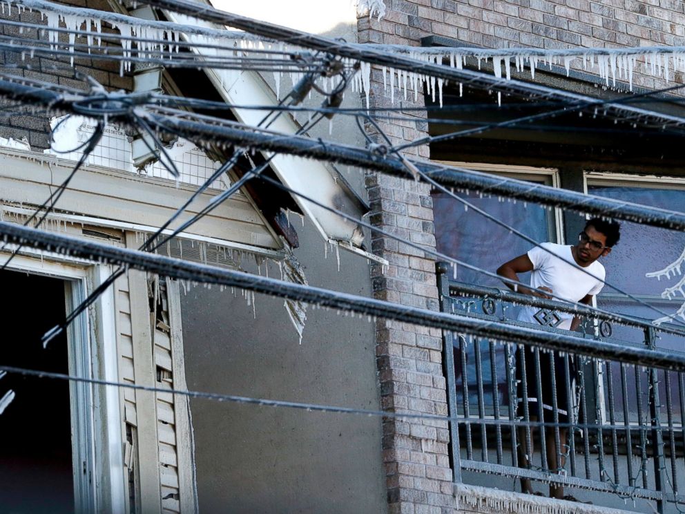 PHOTO: A man looks in the direction of an adjacent home which caught fire overnight on Jan. 8, 2015, in Jersey City, N.J.