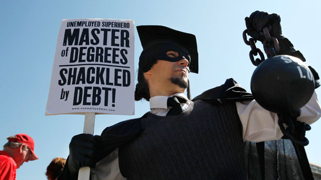 PHOTO: Gan Golan of Los Angeles, dressed as the "Master of Degrees," holds a ball and chain representing his college loan debt during Occupy DC activities in Washington.