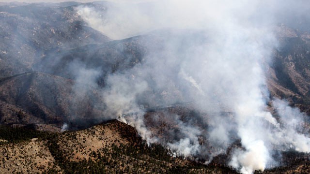 PHOTO: In this aerial photograph, smoke rises from the Lower North Fork Wildfire as it burns near the foothills community of Conifer, Colo., southwest of Denver, March 27, 2012.