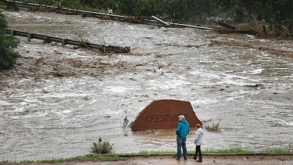 PHOTO: Local residents look over a road washed out by a torrent of water following overnight flash flooding near Left Hand Canyon, south of Lyons, Colo., on Sept 12, 2013.