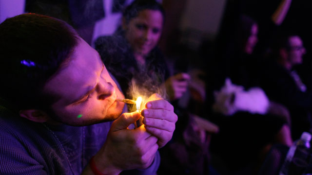 PHOTO: A man smokes marijuana on the official opening night of Club 64, a marijuana-specific social club, where a New Years Eve party was held, in Denver, Dec. 31, 2012.