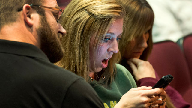 PHOTO: Parent Christy Gorst reacts while reading on her phone a news account detailing the plot by fifth-graders to kill classmates at Fort Colville Elementary School, Feb. 13, 2013 during Colville Schools Security Forum in Colville, Wash.