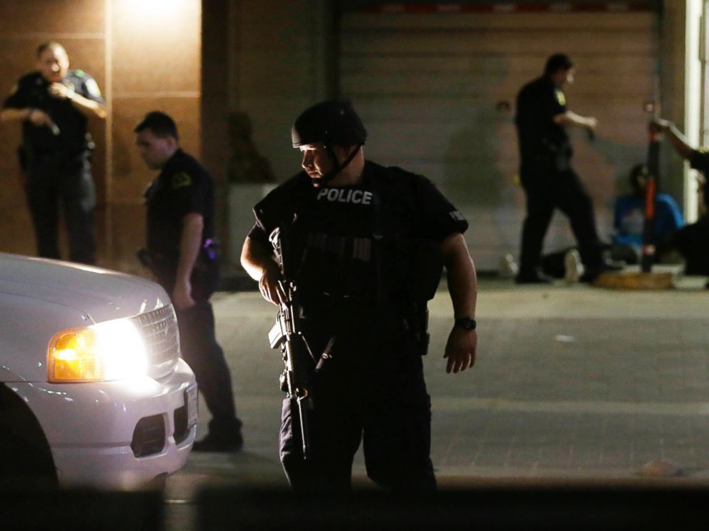 PHOTO: Dallas police detain a driver after several police officers were shot in downtown Dallas, July 7, 2016.