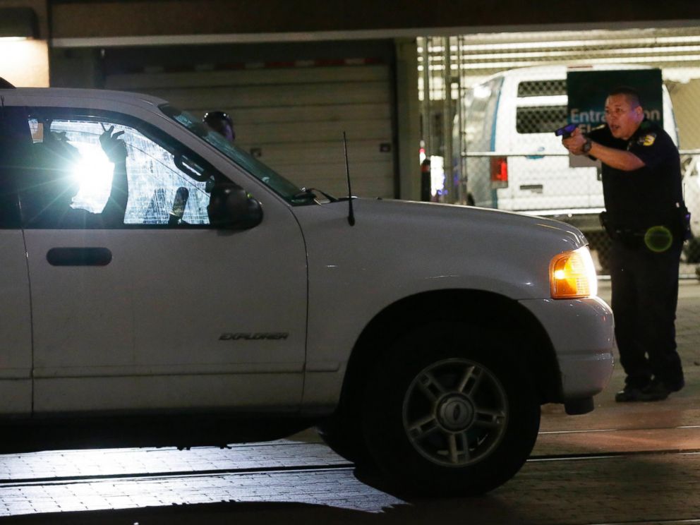 PHOTO: Dallas police stop a driver in downtown Dallas, July 7, 2016, following shootings of police officers.