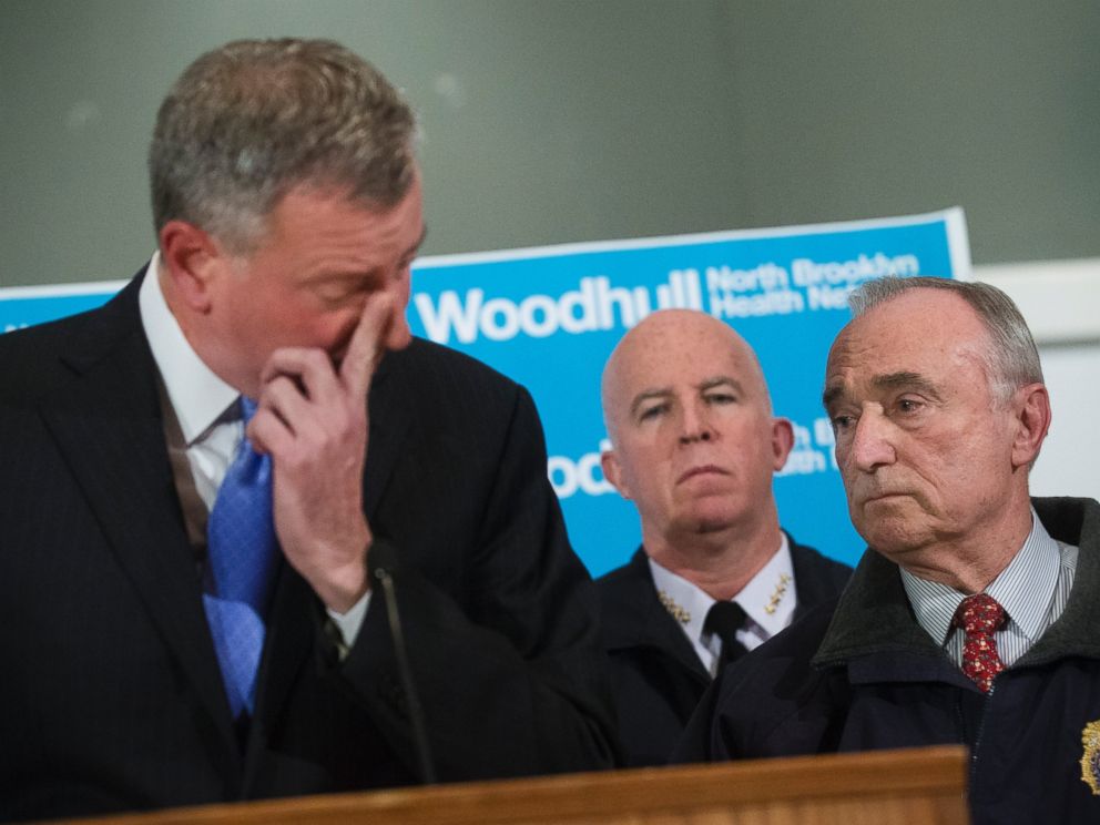 PHOTO: NYPD Commissioner Bill Bratton, right, stands beside Mayor Bill de Blasio as he wipes his eye during a news conference at Woodhull Medical Center, Saturday, Dec. 20, 2014, in New York.