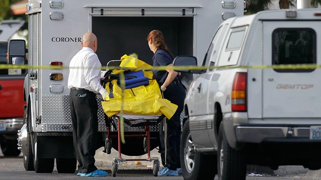 PHOTO: Las Vegas Coroner helps load a gurney holding a homicide victim into the back of a truck on April 16, 2012, in Las Vegas.