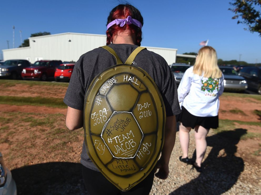 PHOTO: Kortnie Lanclos, of Liberty, S.C., wears a Teenage Mutant Ninja Turtles shell before a superhero-themed funeral service for Jacob Hall at Oakdale Baptist Church, Oct. 5, 2016, in Townville, South Carolina. 