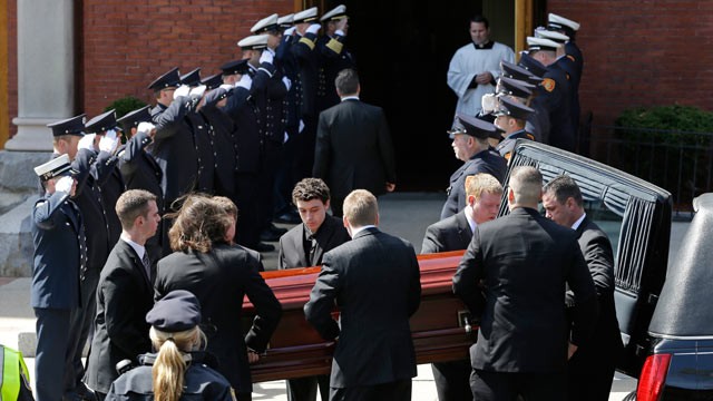 PHOTO: An honor guard from area Fire Departments salute as pallbearers carry the casket of Boston Marathon bomb victim Krystle Campbell into St. Josephs Church for her funeral in Medford, Mass., April 22, 2013.