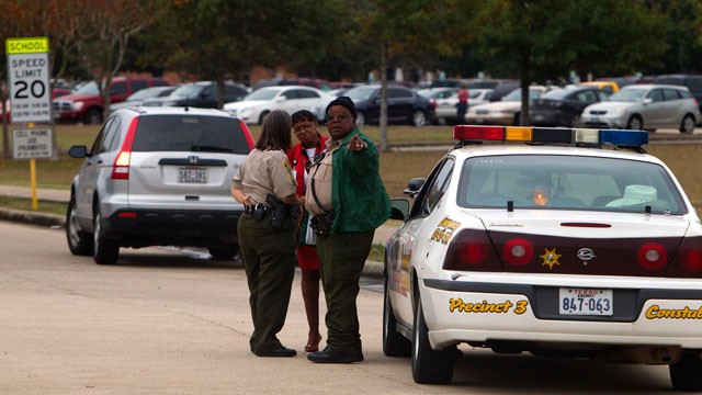 PHOTO: Law enforcement officials gather outside North Shore High School in Galena Park, Texas on Dec. 5, 2012, after police say a high school student shot himself while in the back of a patrol.