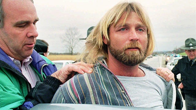 PHOTO: Kentucky state police detective Bob Stephens, left, puts Glen Rogers into a police cruiser after Rogers was arrested, Nov. 13, 1995, near rural Waco, Ky.