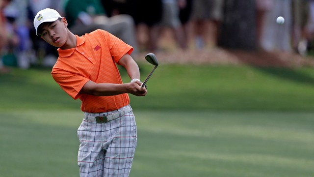 PHOTO: Amateur Guan Tianlang, of China, chips to the first green during the second round of the Masters golf tournament Friday, April 12, 2013, in Augusta, Ga.