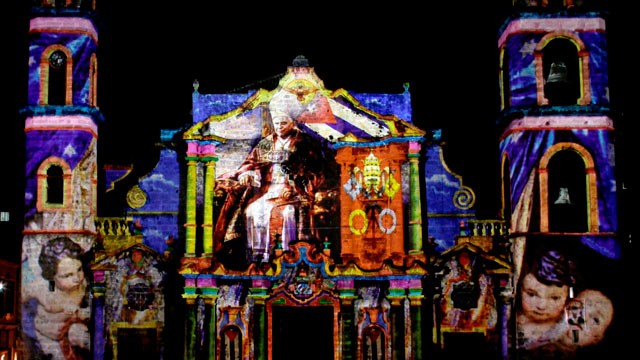 PHOTO: Images of Pope Benedict XVI, by the French-Italian artist Gaspare Di Caro, are projected on the facade of the cathedral in Havana, Cuba on March 25, 2012.