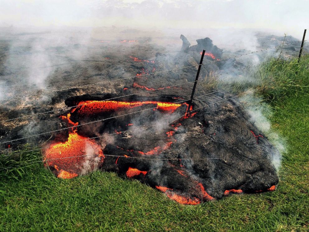 PHOTO: Lava flow advances across the pasture between the Pahoa cemetery and Apaa Street, engulfing a barbed wire fence, near the town of Pahoa on the Big Island of Hawaii, Oct. 25, 2014.