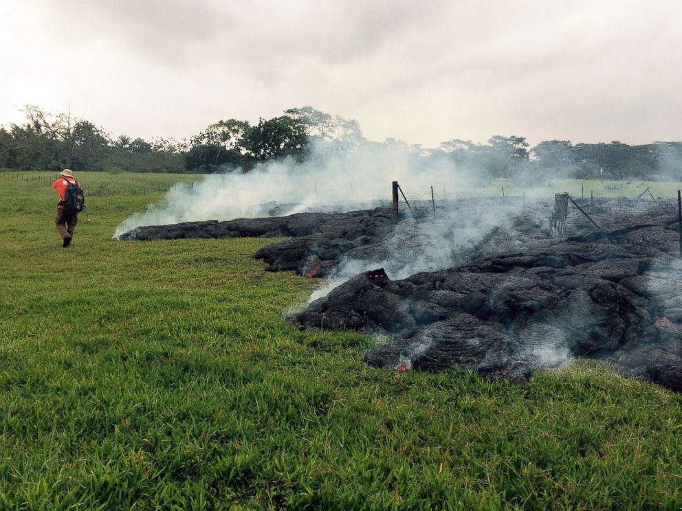 PHOTO: A Hawaii Volcano Observatory geologist maps the margin of the June 27 lava flow in the open field below Cemetery Road near the town of Pahoa on the Big Island of Hawaii, Oct. 26, 2014.