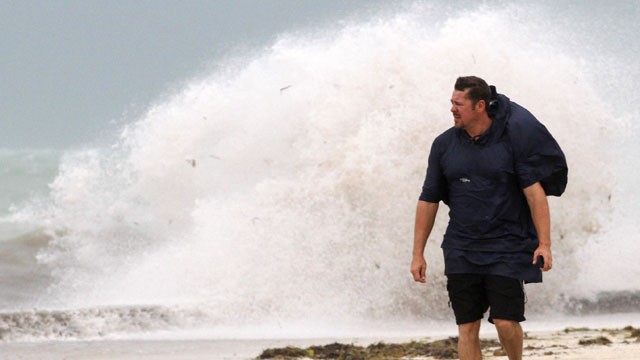 PHOTO: A man walks on the beach in Key West, Fla., Sunday, Aug. 26, 2012 as heavy winds hit the northern coast from Tropical Storm Isaac.