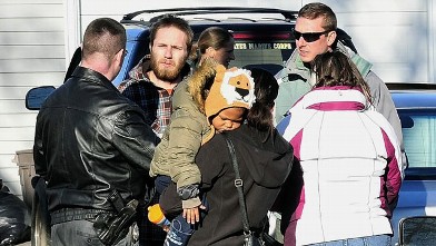 PHOTO: Maine State Police Det. Christopher Tupper, left, and Waterville Det. Lincoln Ryder, right, question Justin DiPietro, second from left, after he arrived at his home in Waterville.