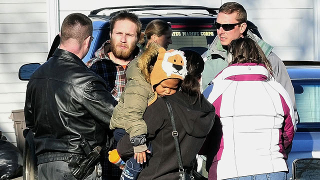 PHOTO: Maine State Police Det. Christopher Tupper, left, and Waterville Det. Lincoln Ryder, right, question Justin DiPietro, second from left, after he arrived at his home in Waterville.