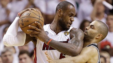 San Antonio Spurs guard Tony Parker (9) and Miami Heat forward LeBron James (6) collide during the second half of Game 6 of their NBA Finals basketball series, June 18, 2013 in Miami.