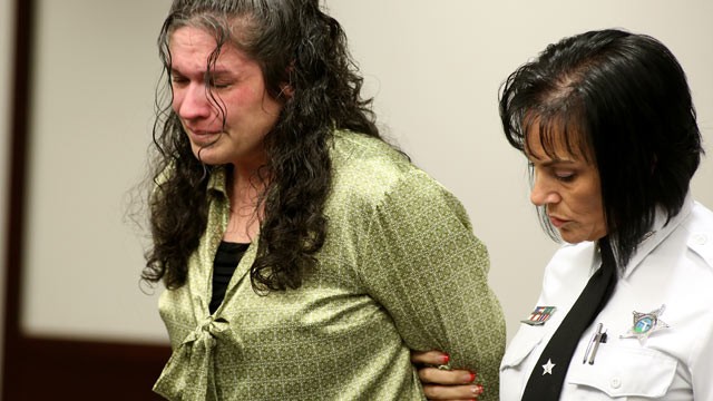 PHOTO: Defendant Dorice Moore, left cries as she is led out of the courtroom for a lunch break after listening to a secret audio recording made by informant Greg Smith during Moores murder trial on Dec. 4, 2012 in Tampa, Fla.