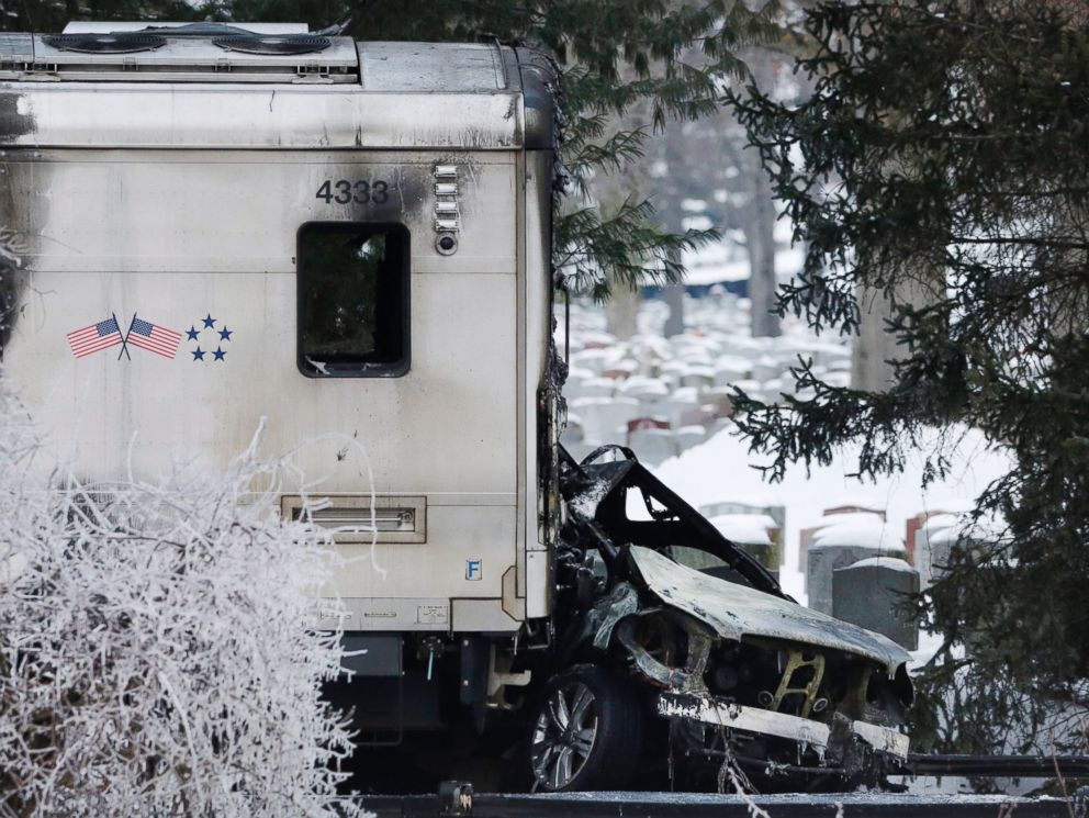 PHOTO: A sports utility vehicle remains crushed and burned at the front of a Metro-North train, on Feb. 4, 2015, in Valhalla, N.Y.