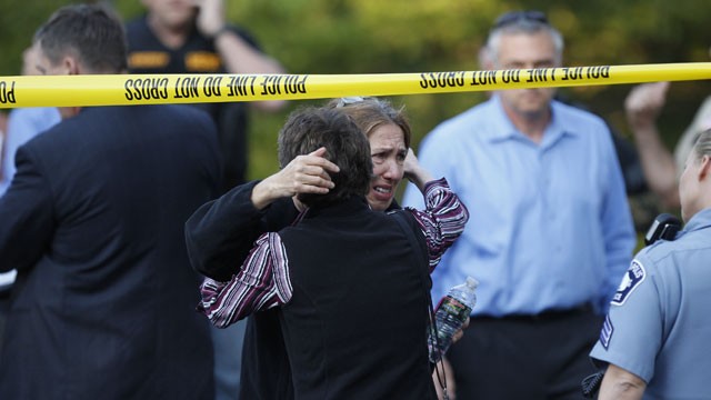 PHOTO: An unidentified woman is consoled at the scene of a shooting that left at least two dead and four others wounded at Accent Signage Systems in Minneapolis, Thursday, Sept. 27, 2012.
