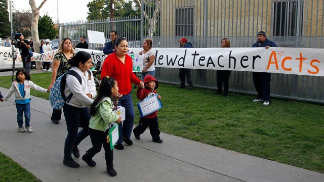 PHOTO: Parents bring their children to school as others protest outside Miramonte Elementary school in Los Angeles Feb. 6, 2012.