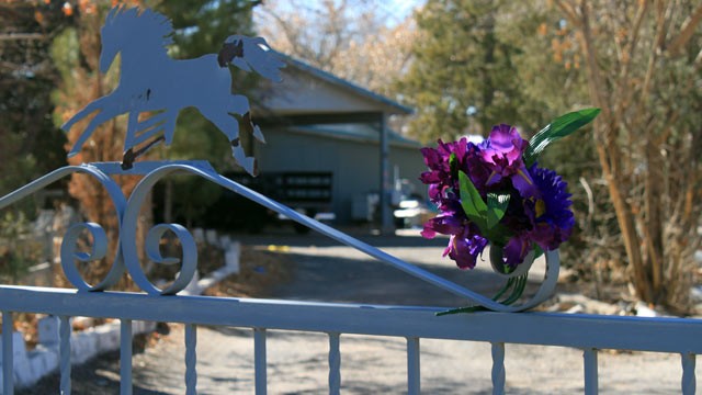 PHOTO: A bouquet of flowers adorns the entrance to a home on Jan. 21, 2013, where a couple and their three young children were found shot to death south of Albuquerque, N.M.