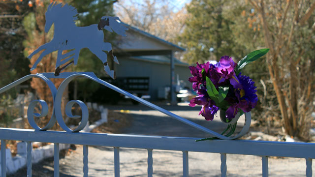 PHOTO: A bouquet of flowers adorns the entrance to a home on Jan. 21, 2013, where a couple and their three young children were found shot to death south of Albuquerque, N.M.