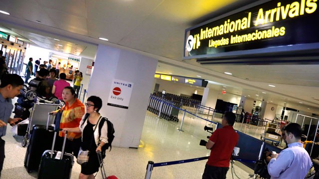 PHOTO: Airline passengers arriving from Hong Kong walk from the international arrivals area at Newark Liberty Airport, June 17, 2013, in Newark, N.J.