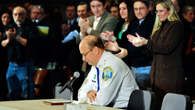 PHOTO: Newtown Chief of Police Michael Kehoe receives a standing ovation from families of the victims of the Sandy Hook Elementary School shooting during a hearing to a legislative task force on gun violence and childrens safety at Newtown High School in