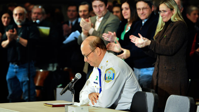 PHOTO: Newtown Chief of Police Michael Kehoe receives a standing ovation from families of the victims of the Sandy Hook Elementary School shooting during a hearing to a legislative task force on gun violence and childrens safety at Newtown High School in