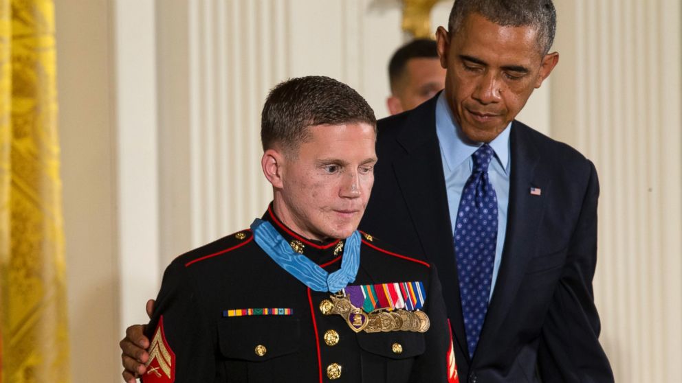 PHOTO: President Barack Obama reaches out to retired Marine Cpl. William "Kyle" Carpenter, after awarding him the Medal of Honor for conspicuous gallantry, June 19, 2014, during a ceremony in the East Room of the White House in Washington.