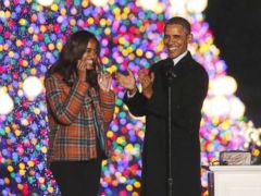 PHOTO: President Barack Obama, first lady Michelle Obama, daughters Sasha and Malia, applaud after lighting the National Christmas Tree at a ceremony across from the White House in Washington, Dec. 6, 2013.