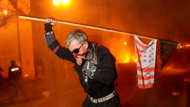 PHOTO: Occupy Oakland protester runs from teargas on Nov. 3, 2011 in Oakland, Calif.