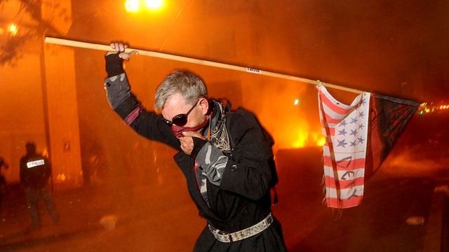 PHOTO: Occupy Oakland protester runs from teargas on Nov. 3, 2011 in Oakland, Calif.