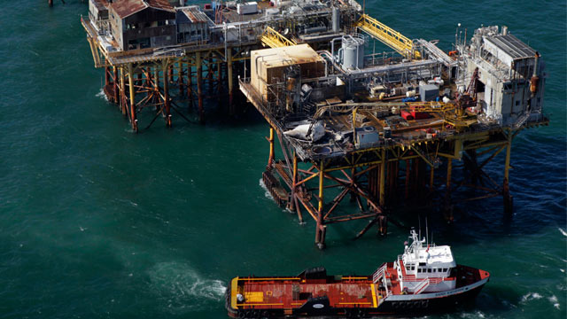 PHOTO: A supply vessel moves near an oil rig damaged by an explosion and fire, Nov. 16, 2012, in the Gulf of Mexico about 25 miles southeast of Grand Isle, La.