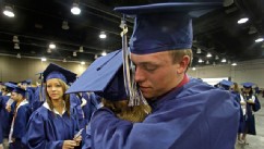PHOTO: Southmoore High School senior Jake Spradling, hugs a classmate as they get ready to attend their commencement ceremony in Oklahoma City Saturday, May 25, 2013, five days after a tornado destroyed a large swath of their attendance area in Moore, Okl
