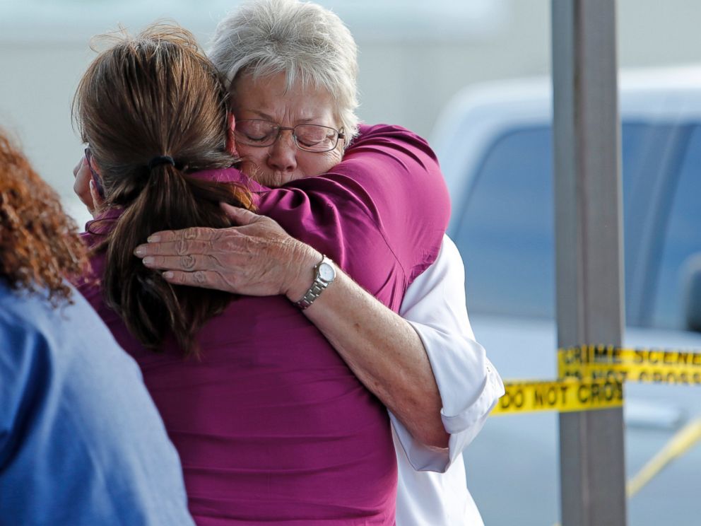 PHOTO: Employees and friends wait behind police tape for word of loved ones as police investigate an incident at Vaughn Foods on Sept. 25, 2014 in Moore, Okla.