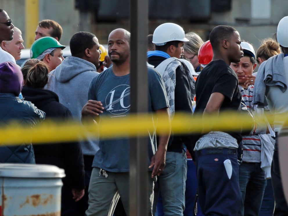 PHOTO: Employees wait in the parking lot as police investigate at Vaughn Foods on Sept. 25, 2014 in Moore, Okla.